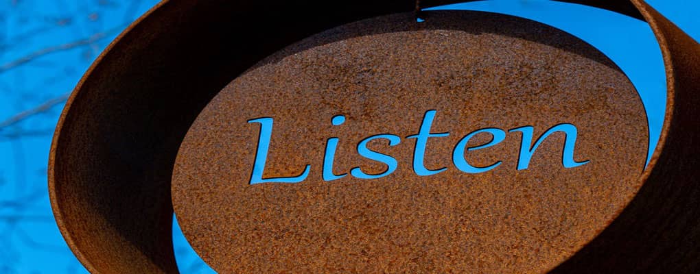 Sign with 'Listen' written on it